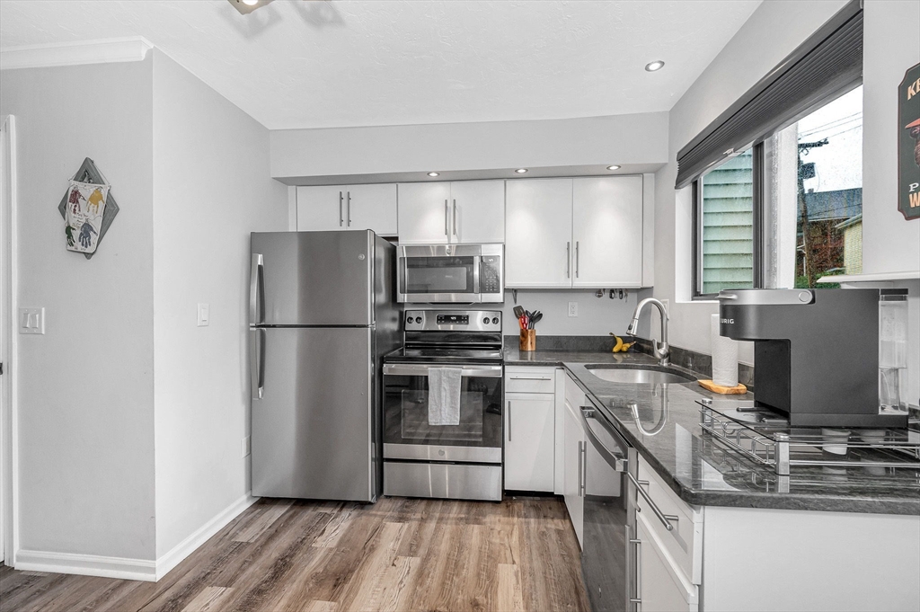 22 River Street, Unit 13 Hudson, MA 01749 - Photo 2 of 23 a kitchen with a refrigerator stove and sink