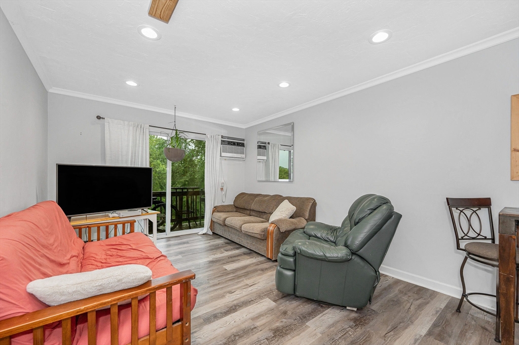 22 River Street, Unit 13 Hudson, MA 01749 - Photo 8 of 23 a living room with furniture and a flat screen tv