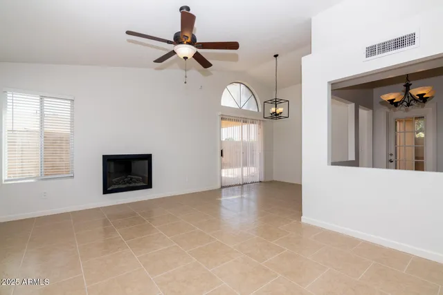 a view of an empty room with a ceiling fan