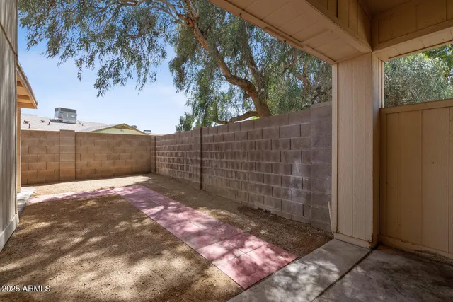 a view of a entrance gate of a house with a patio