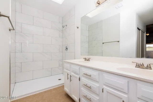 a view of a room with a ceiling fan and wooden floor