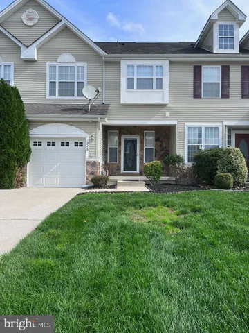 a view of a yard in front of a brick house
