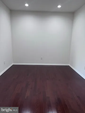 an empty room with wooden floor
