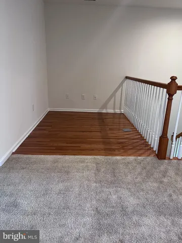 a view of room with wooden floor