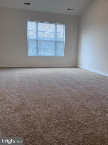 an empty room with a empty space and windows