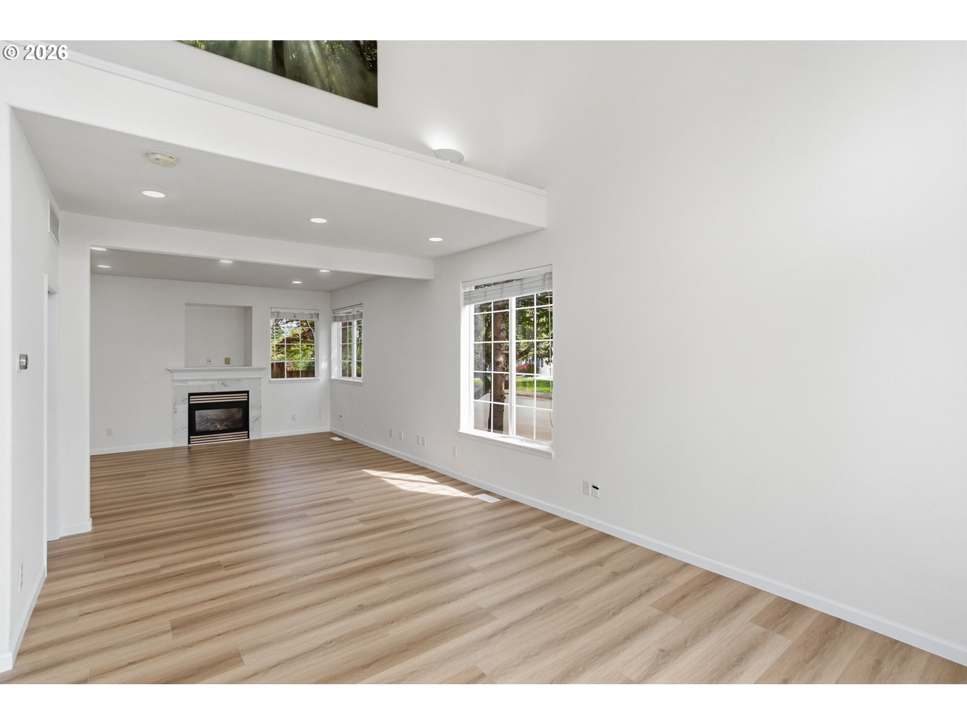 8911 Southwest Gravenstein Lane Tigard, OR 97224 - Photo 9 of 33 a view of an empty room with wooden floor and a window