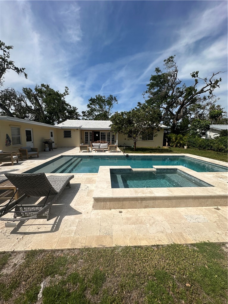 530 Cypress Road Vero Beach, FL 32963 - Photo 36 of 36 a view of a swimming pool with an outdoor seating and a yard