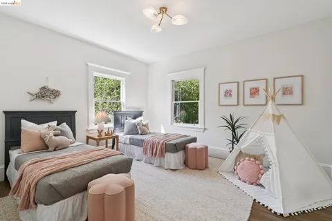 a bedroom with furniture and a large window