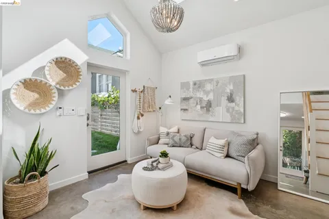 a living room with furniture potted plant and a window