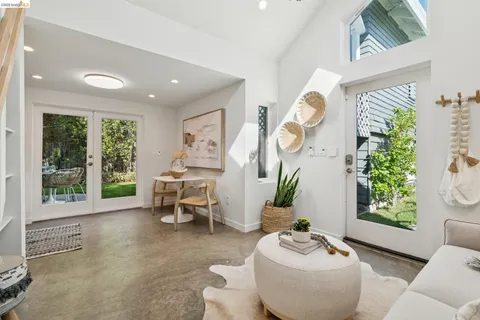 a living room with furniture and a floor to ceiling window