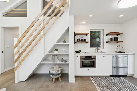 a kitchen with stainless steel appliances granite countertop a stove and white cabinets