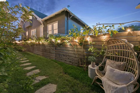 a backyard of a house with table and chairs