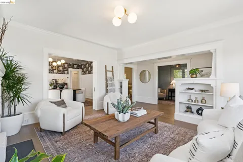 a living room with furniture and a dining table