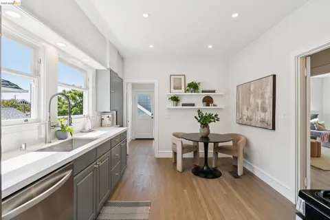 a dining room with furniture and wooden floor