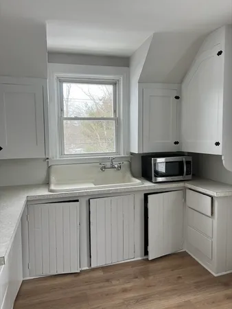 a kitchen with a sink and wooden cabinets