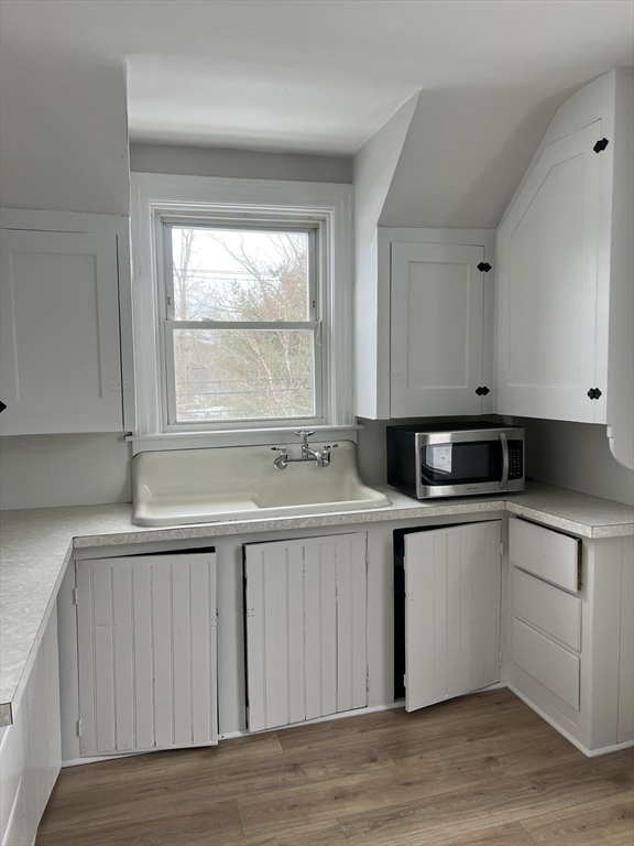 134 Bay State Road, Unit 2 Rehoboth, MA 02769 - Photo 3 of 18 a kitchen with a sink and wooden cabinets