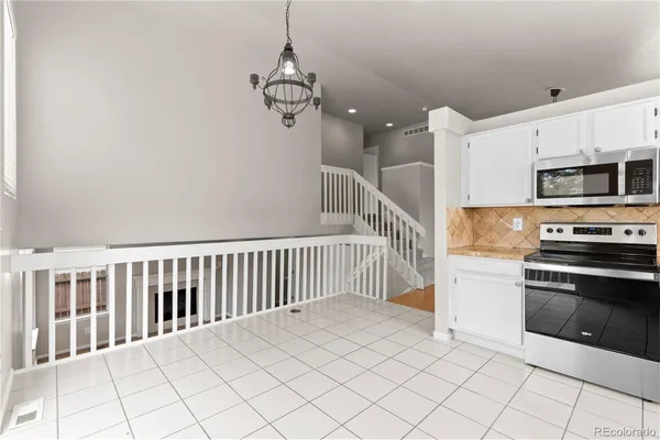 a view of a kitchen with microwave and cabinets