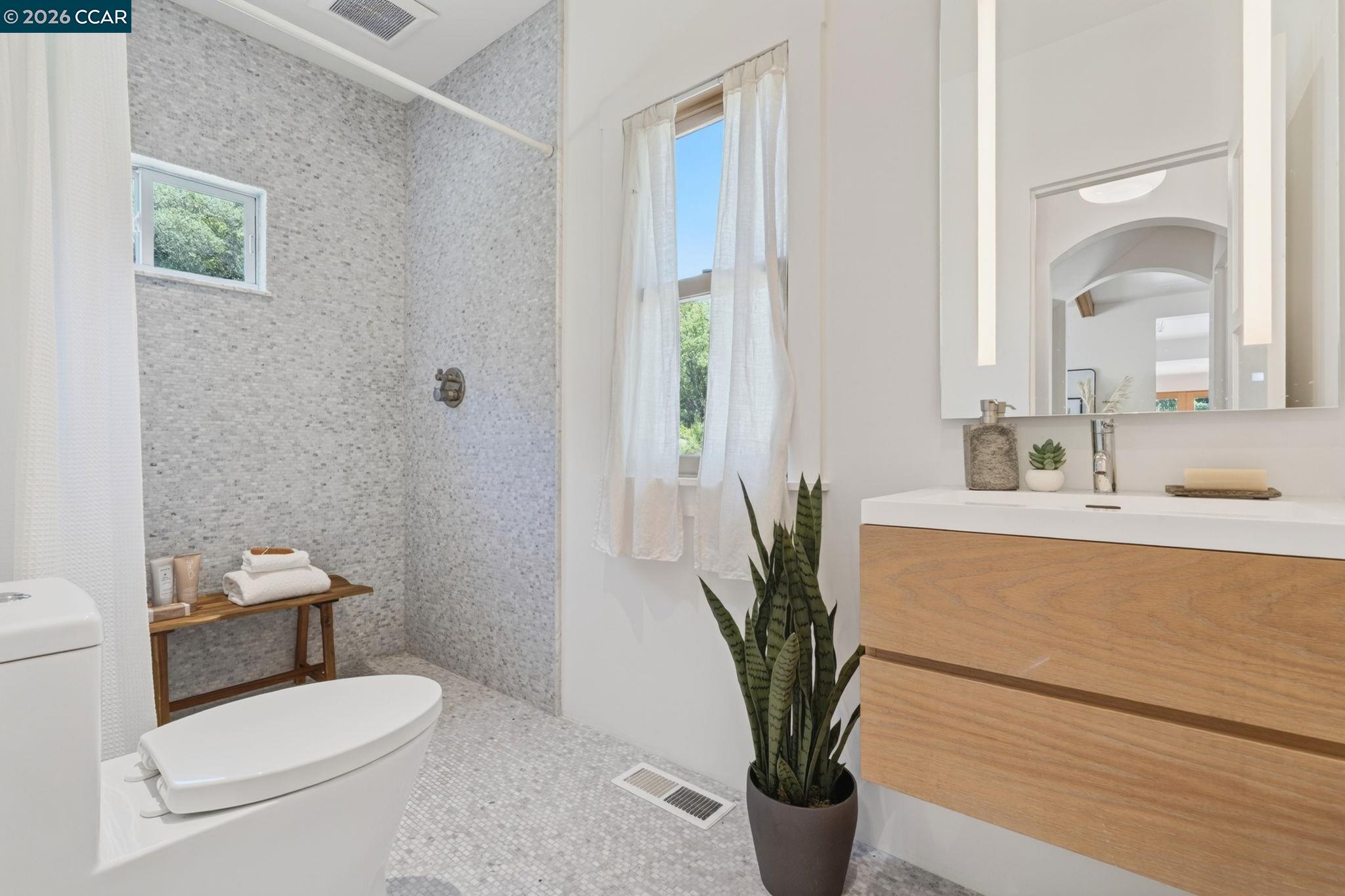 4009 Redwood Road Napa, CA 94558 - Photo 24 of 91 a bathroom with a toilet a sink and a mirror