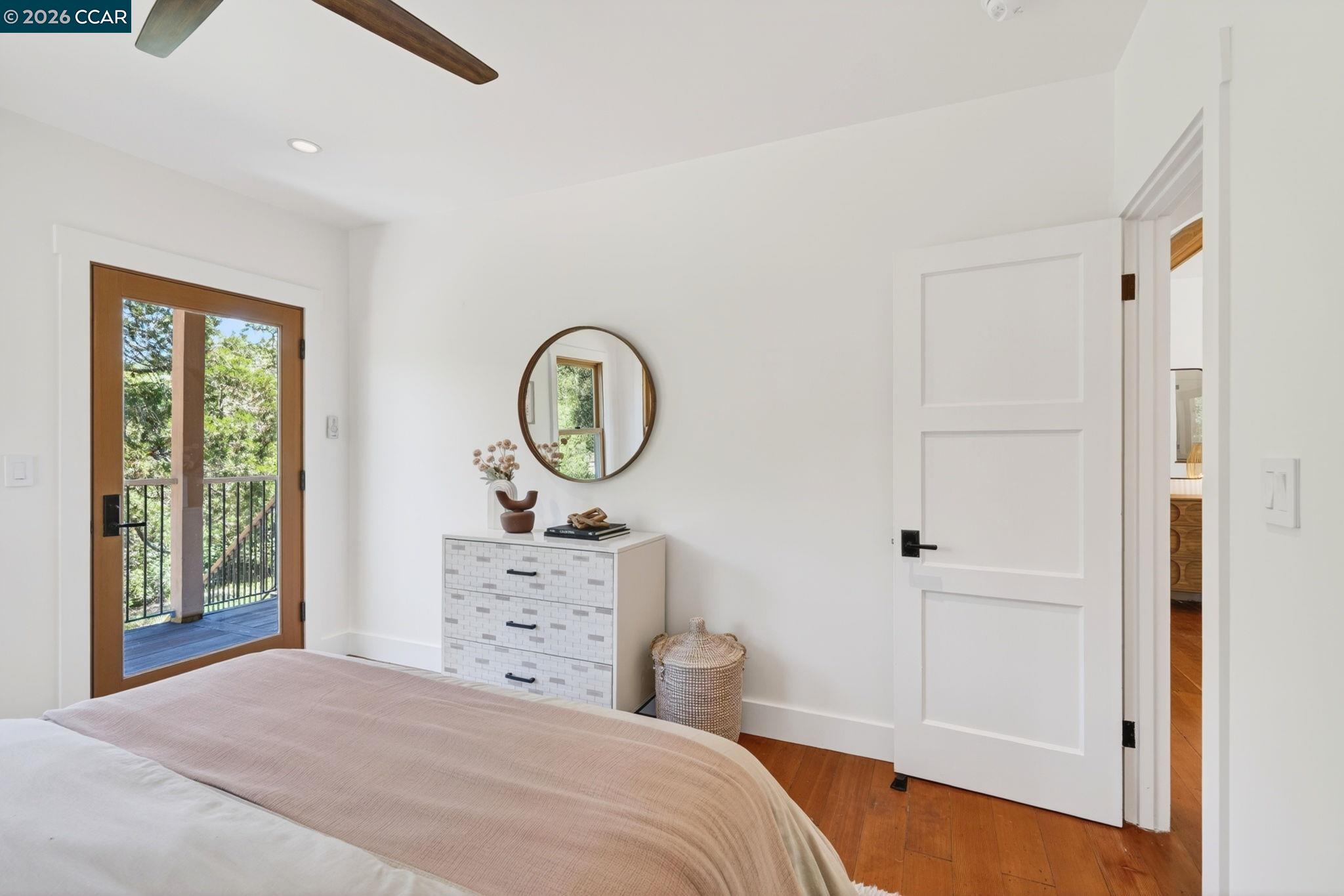 4009 Redwood Road Napa, CA 94558 - Photo 27 of 91 a bedroom with a bed a mirror on the dresser and a window