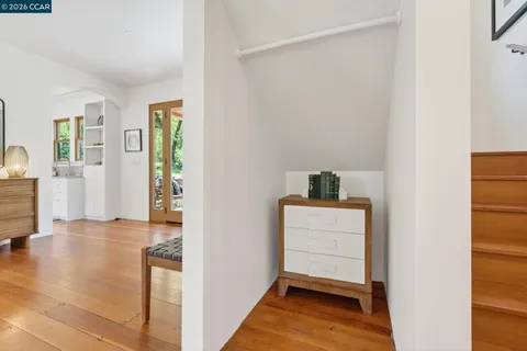 a view of entryway and hall with wooden floor