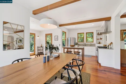a view of a patio with table and chairs and wooden floor
