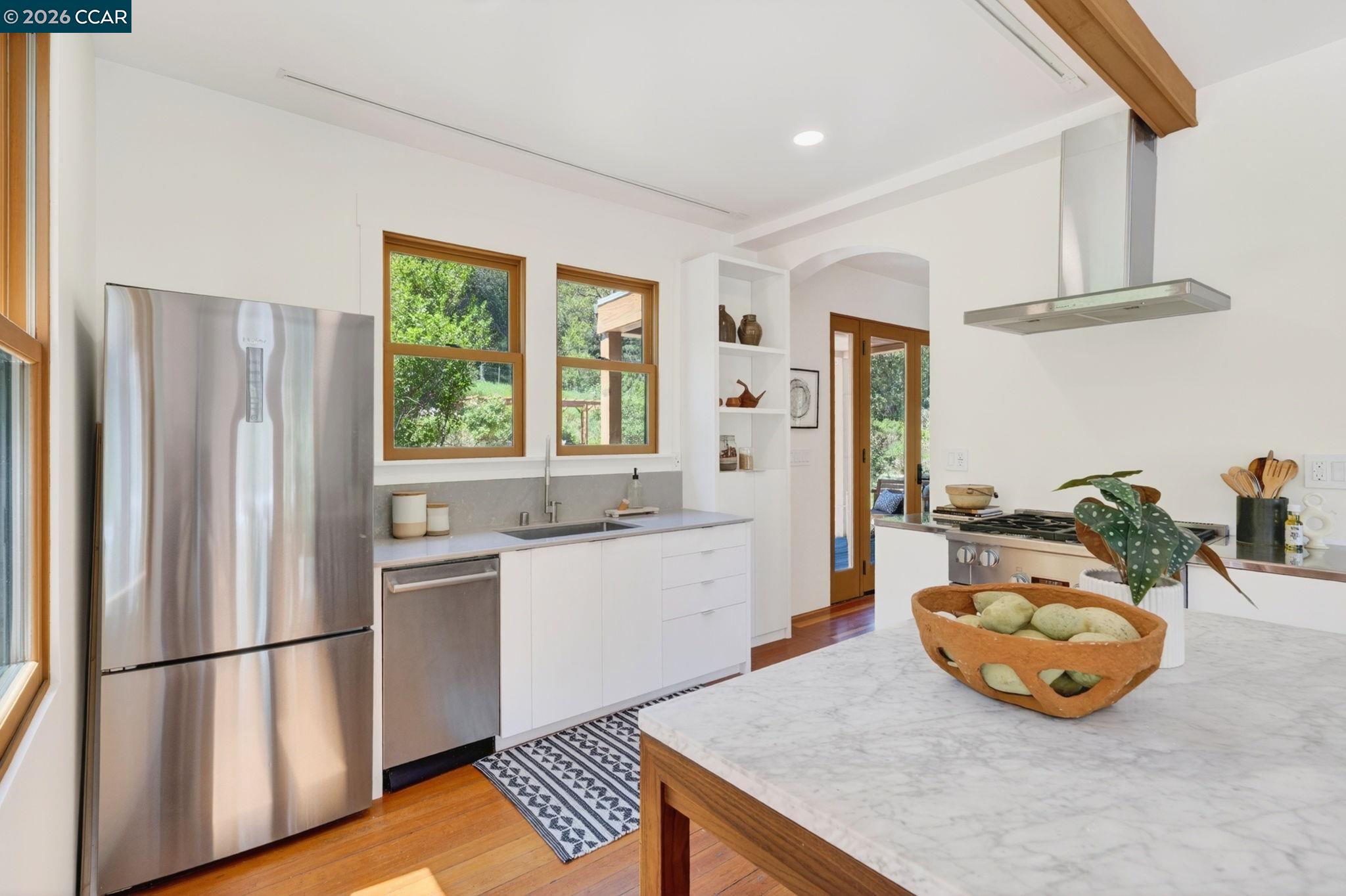 4009 Redwood Road Napa, CA 94558 - Photo 46 of 91 a kitchen with stainless steel appliances a sink a refrigerator and wooden floor