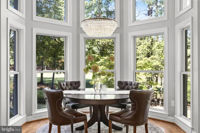 a white bath tub sitting in a bathroom next to a window