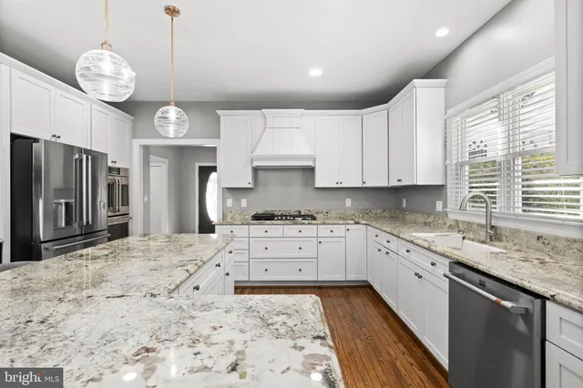 a front view of a house with a garden and trees