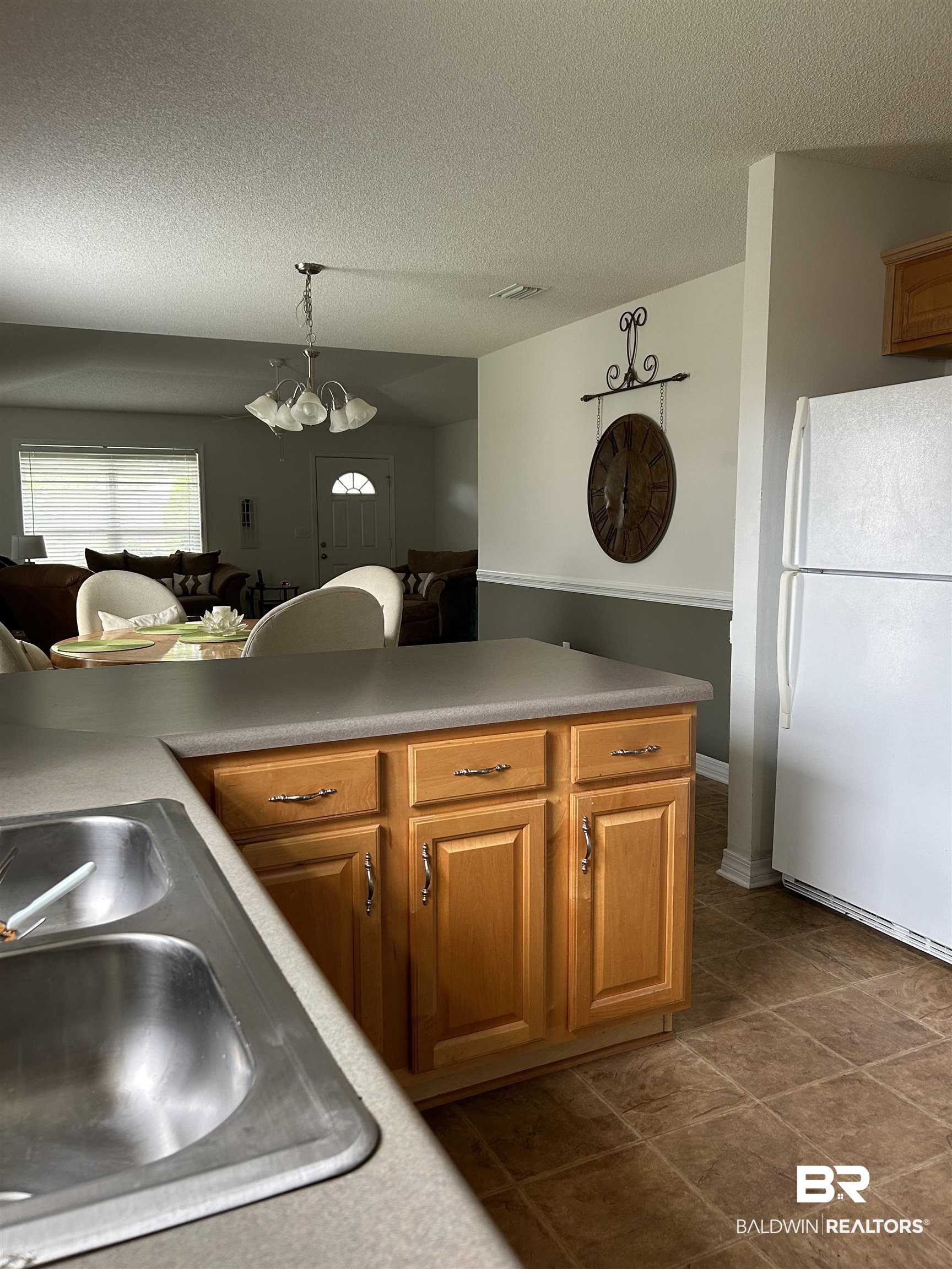 16976 Sugar Loop Foley, AL 36535 - Photo 8 of 16 Kitchen with a textured ceiling, a chandelier, decorative light fixtures, sink, and white refrigerator