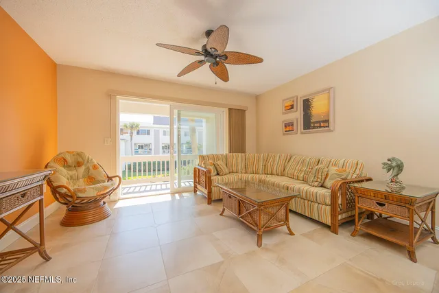 a living room with a chair and a rug