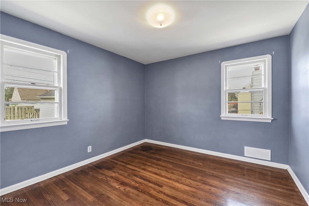 6506 Snow Road Parma, OH 44129 - Photo 15 of 25 Spare room featuring baseboards and dark wood-type flooring