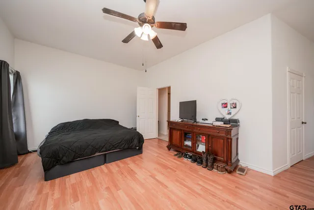 a bedroom with a bed and wooden floor