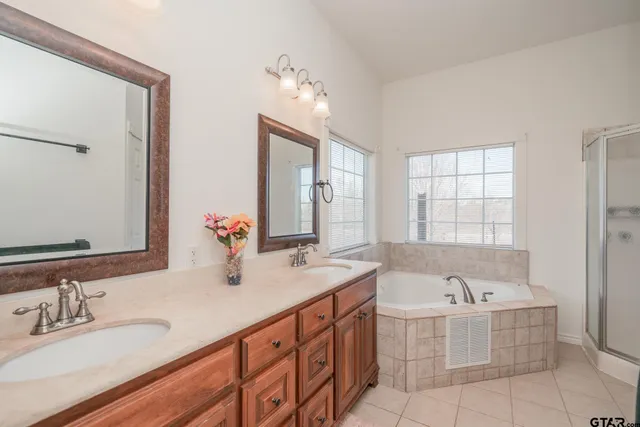 a bathroom with a bathtub and next to a window