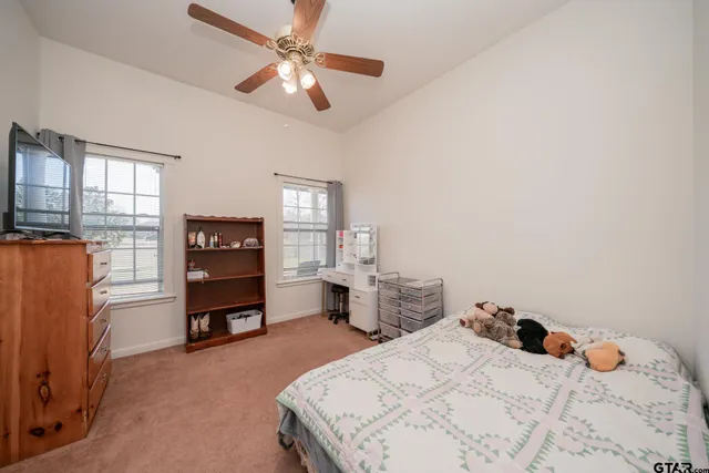 a bedroom with a bed and a desk