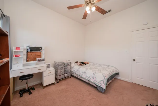 a bedroom with a bed a desk and chair