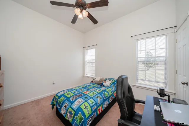 a bedroom with a bed and window