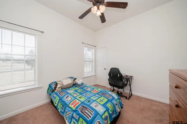 a bathroom with a granite countertop sink and a mirror with toilet