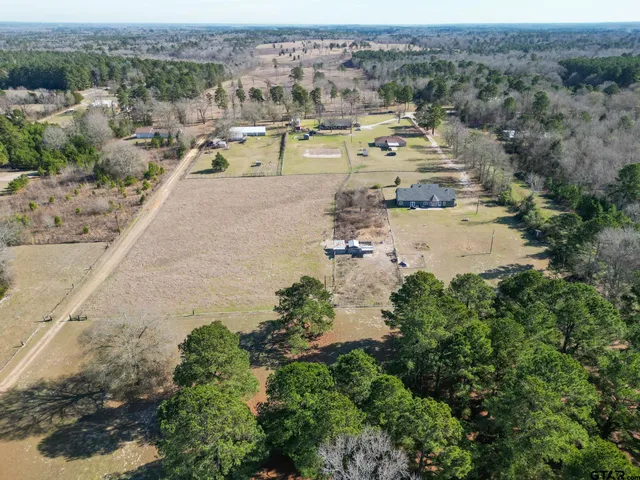 an aerial view of a houses with a yard