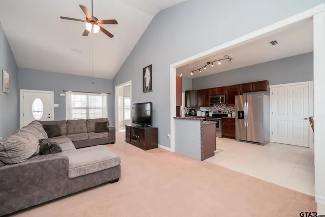 a living room with furniture a kitchen and a fireplace
