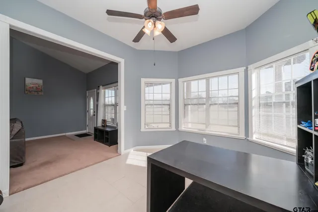 a kitchen with kitchen island granite countertop a stove top oven a sink dishwasher a dining table and chairs with wooden floor