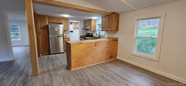 a view of a kitchen with a stove cabinets and wooden floor