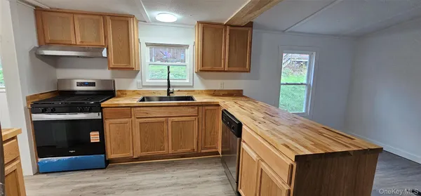 a kitchen with wooden floors and refrigerator
