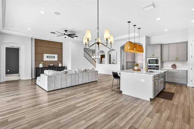 a living room with furniture and a ceiling fan