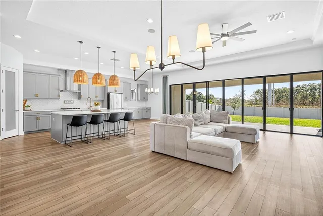 an empty room with fan and windows