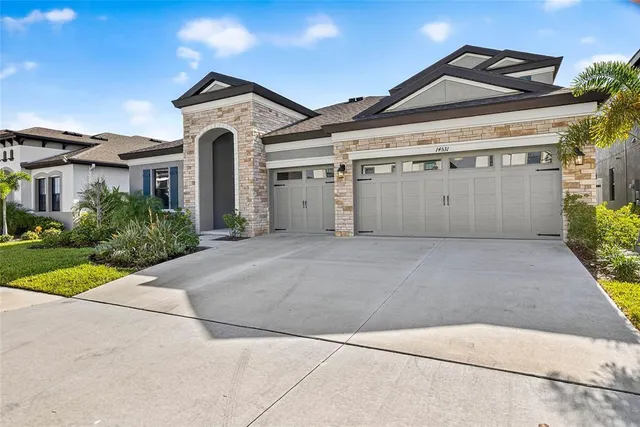 a front view of a house with a yard and garage