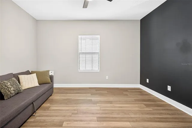 a bedroom with a large bed and a potted plant