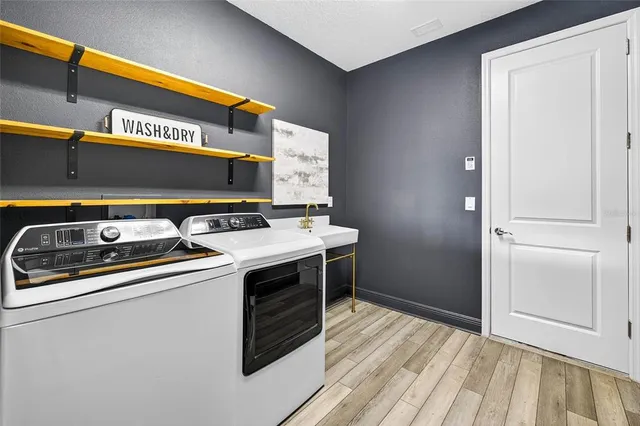 a bed sitting in a spacious bedroom next to a window and a dresser