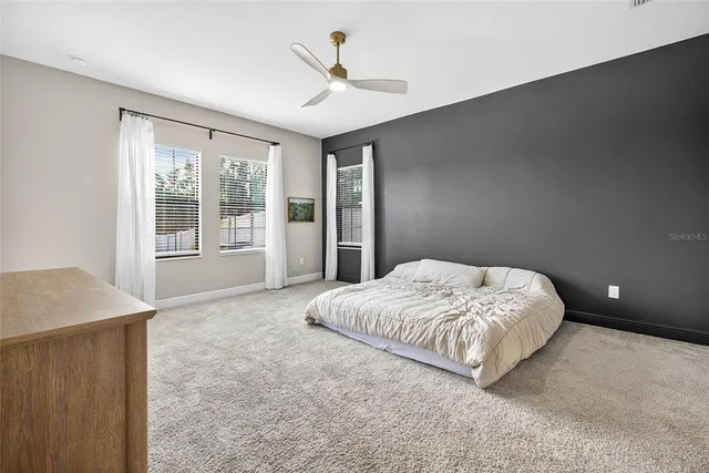 a bathroom with a sink a toilet a mirror and shower