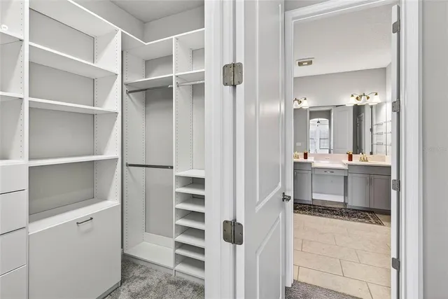 a view of a house with a big yard and palm trees