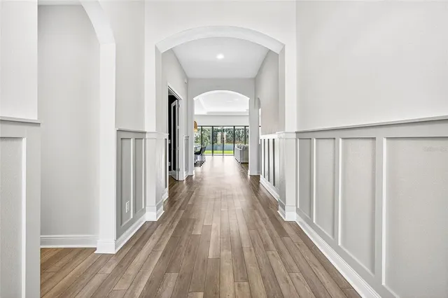 a kitchen with stainless steel appliances granite countertop a stove a refrigerator a sink a dining table and chairs